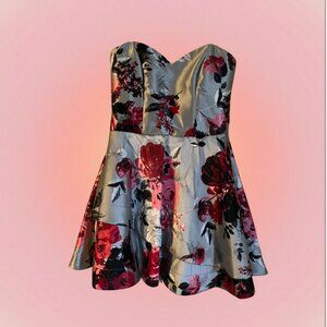 short, off-the-shoulder, silver dress with pink and black roses